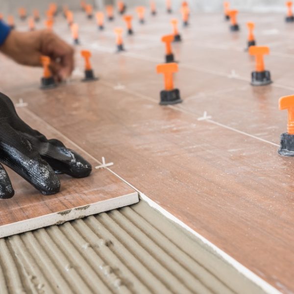 Hand,Tiler,Laying,Tile,Floor,Cement,Glue,,Worker,Furnishing,Ceramic
